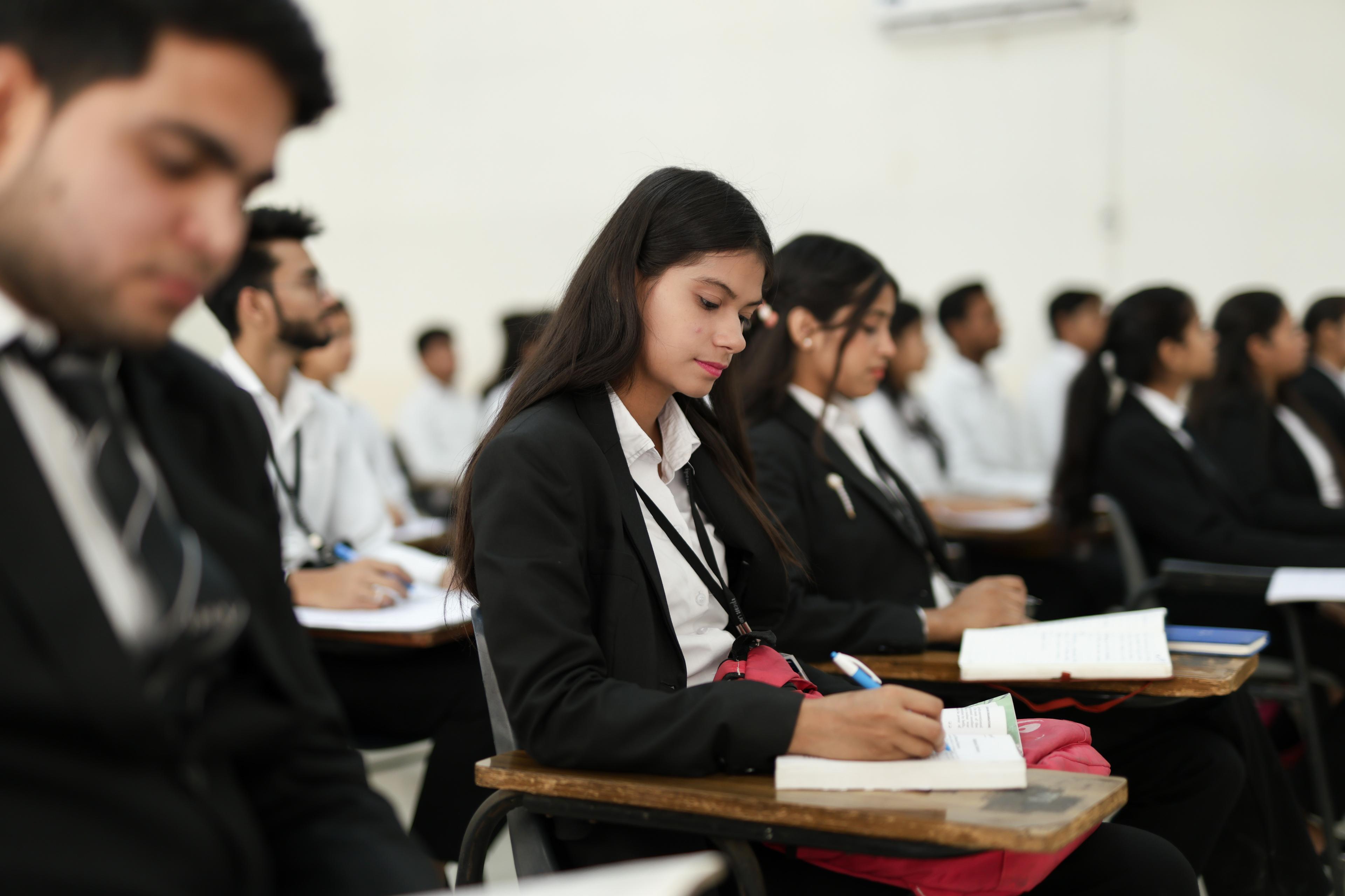 A law student taking notes during class