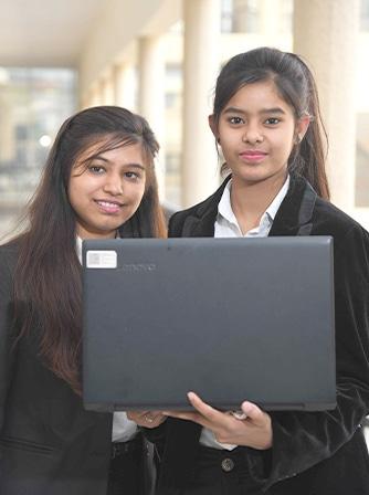 IPEM Law Academy students collaborating on a laptop